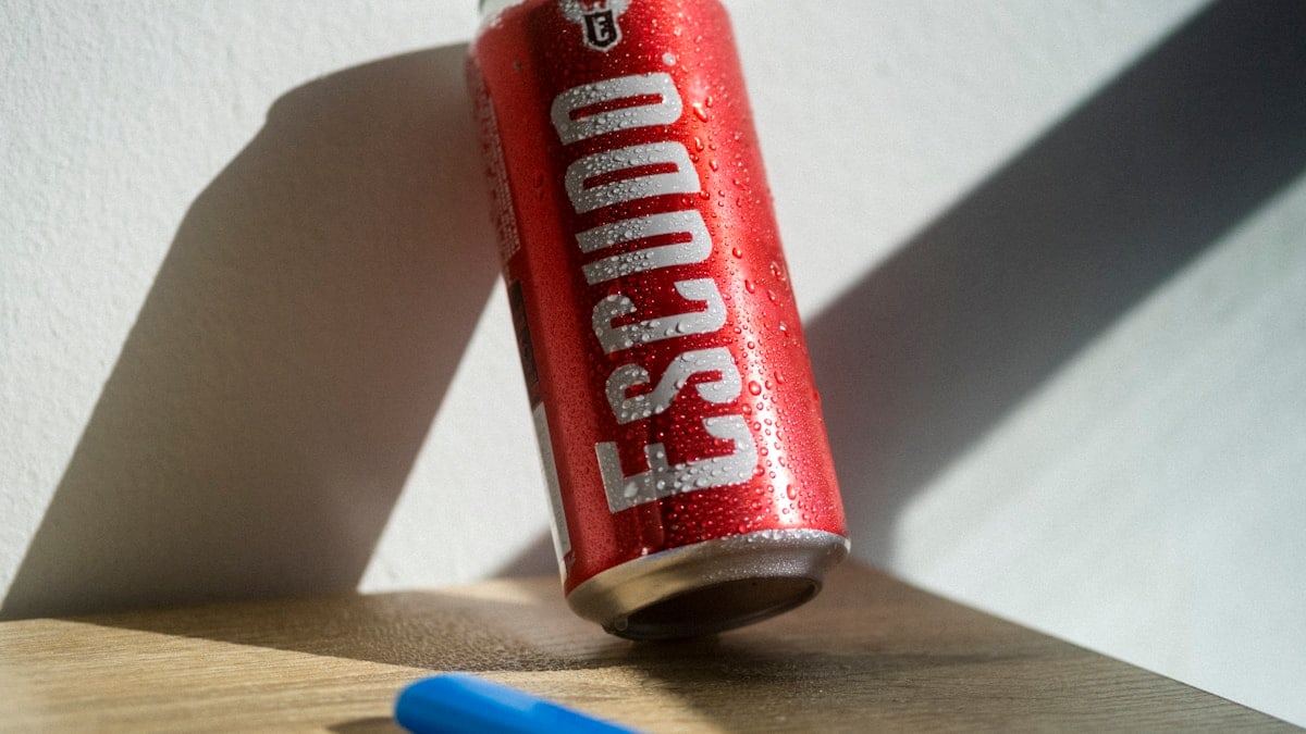 a can of soda sitting on top of a wooden table